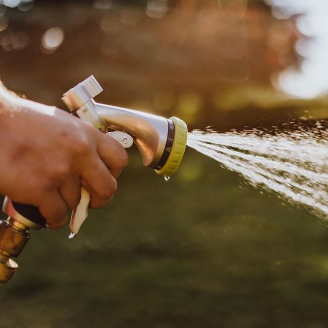 Can I pressure wash my driveway myself or do I need to hire a professional?