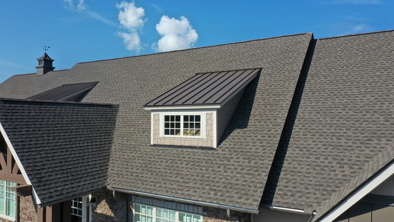 Black streaks of discoloration on shingle roofs in Texas